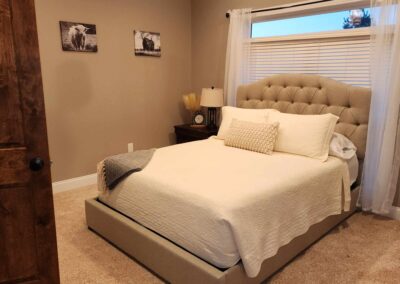 Bedroom with Wood Floors and White Bed with Pillows and Nice Headboard